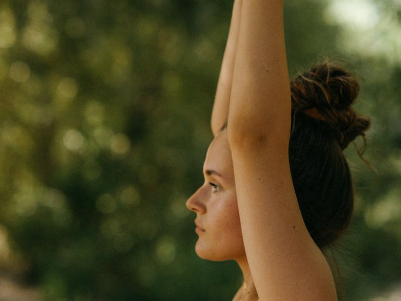 Close-up shot of a person's hands in a meditative pose.